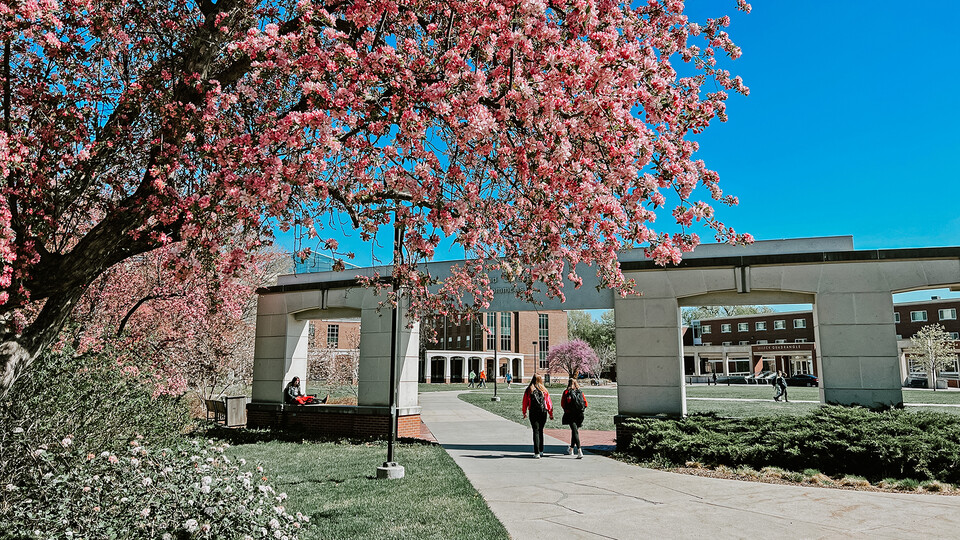 Two students walk near the Meier Commons on UNL's City Campus.