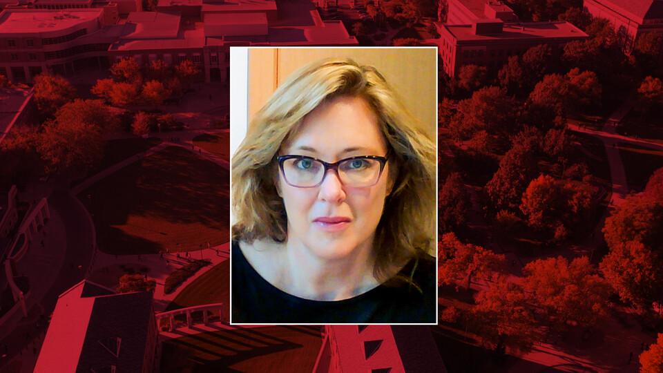 Color photo of Susan Longhenry on red campus background