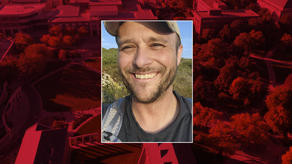 Color photo of Ashley Poust on red campus background