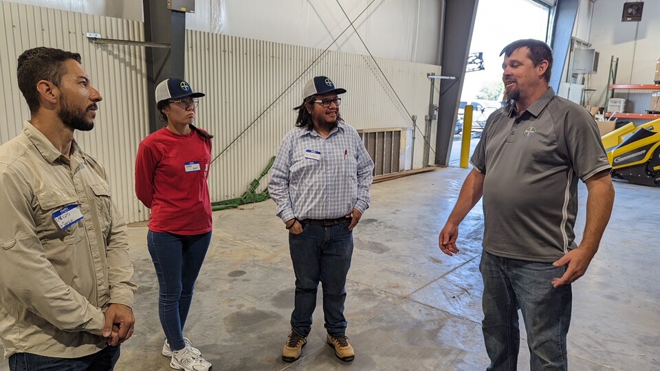 A Bayer staff member (right) at the company's facility in Waco, Texas, speaks with Husker mentees (from left) Marcos Goncalves de Souza, Shara Akat and Boanerges Elias Bamaca.