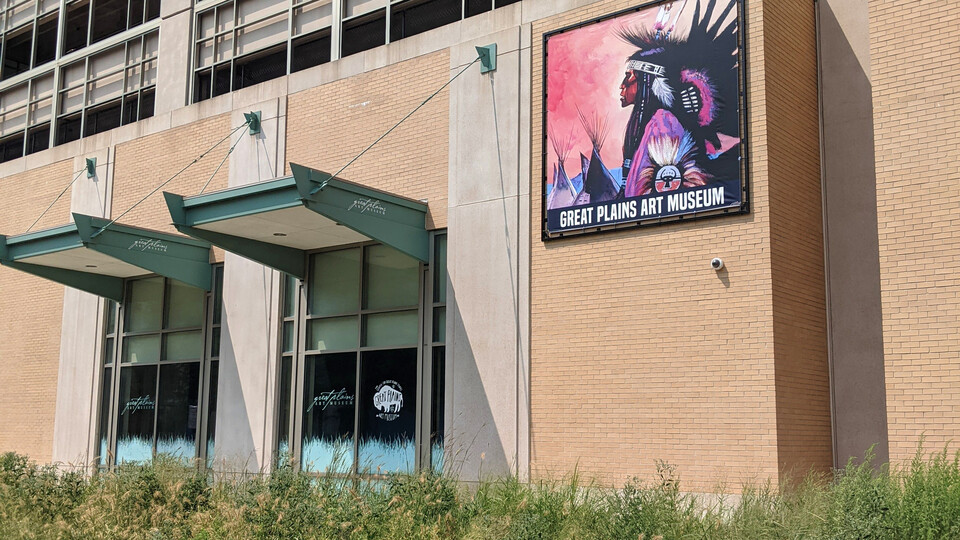 East side of Center for Great Plains Studies, with a poster of a Native man in regalia and the words "Great Plains Art Museum."