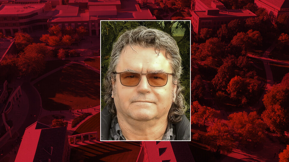 A color portrait of Thomas C. Gannon on a red campus background