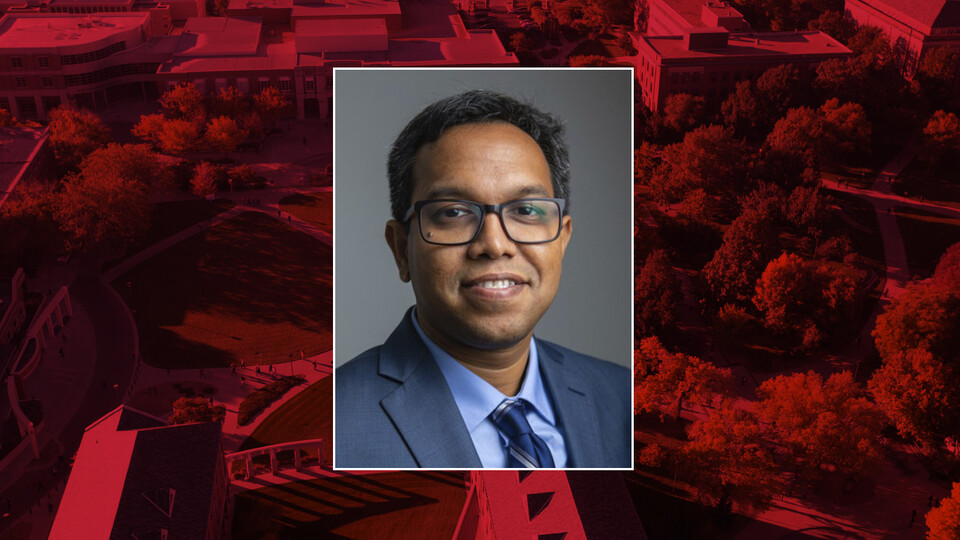 Color portrait of Nirupam Aich on a red campus background