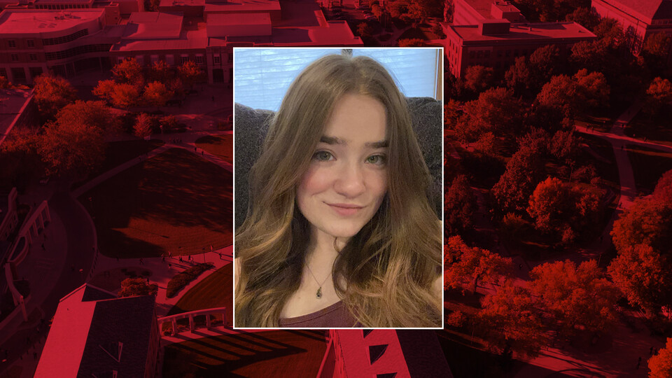 Color portrait of Alice Young on a red campus background