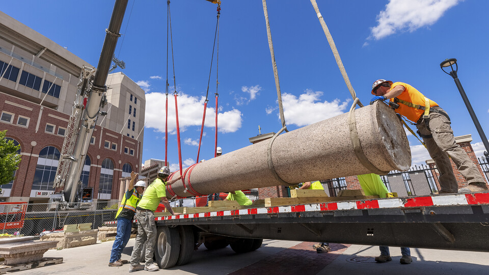 Workers load one of the 24 columns onto a trailer outside of East Memorial Stadium on May 12. The historic columns were removed to make way for the Huskers' $155 million athletics complex.