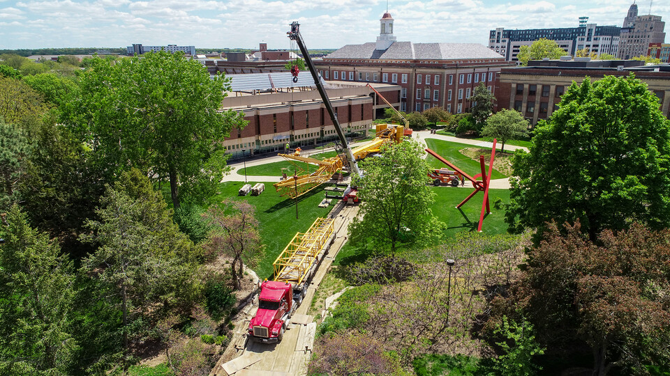 A large crane is being assembled west of Love Library.