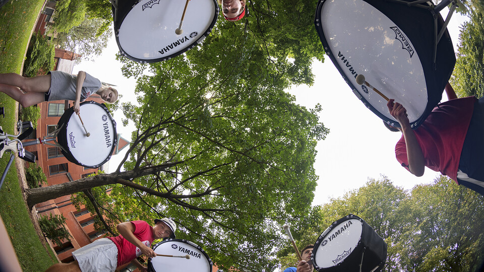 Cornhusker Marching Band percussionists practice in a circle during the first day of fall band camp.