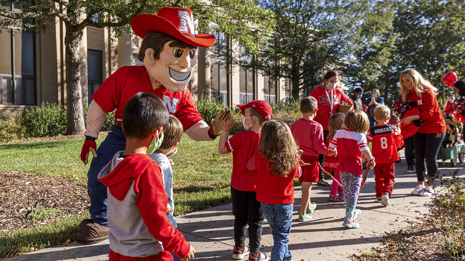 Herbie Husker, spirit squad members and youth from the Ruth Staples Child Development Lab celebrate Campus Childcare Centers Week with a parade on Oct. 4. The Ruth Staples Child Development Lab is part of the award-winning Department of Child, Youth and Family Services.
