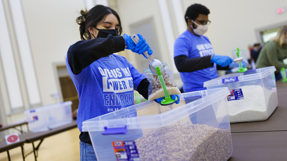 Cynthia Serrano-Ortega (left) and Christian Parrish add beans to meals being packed as part of the university’s MLK Week service project on Jan. 19. Nearly 120 students, faculty and staff volunteers packed more than 2,100 meals to feed the hungry across southeastern Nebraska.
