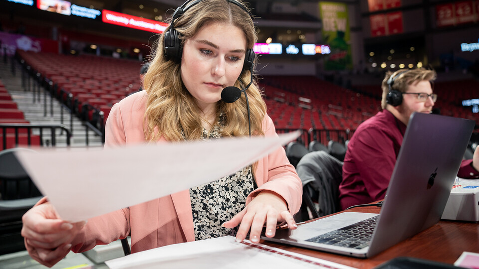Hailey Ryerson organizes her notes before the Husker women’s basketball game against Minnesota at Pinnacle Bank Arena on Feb. 20.
