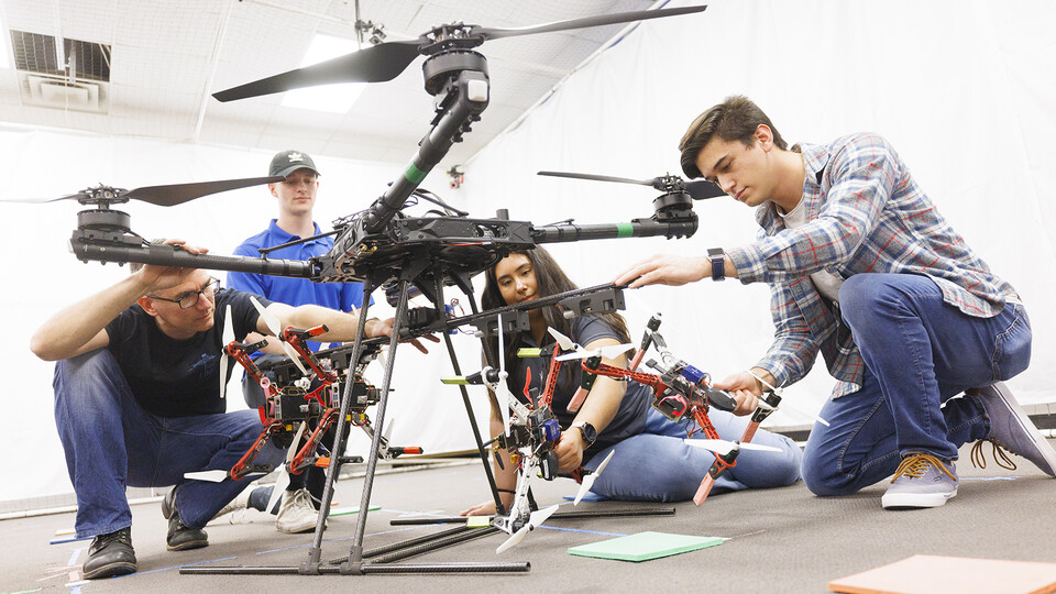 Students working on a drone in a campus lab.