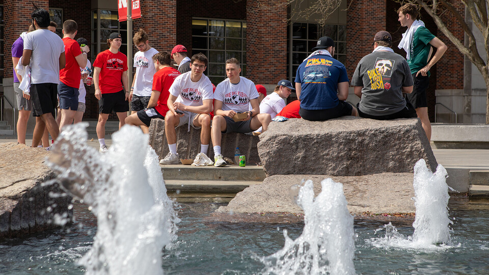 Students await instruction while sitting around Broyhill Fountain outside the Nebraska Union on April 23.