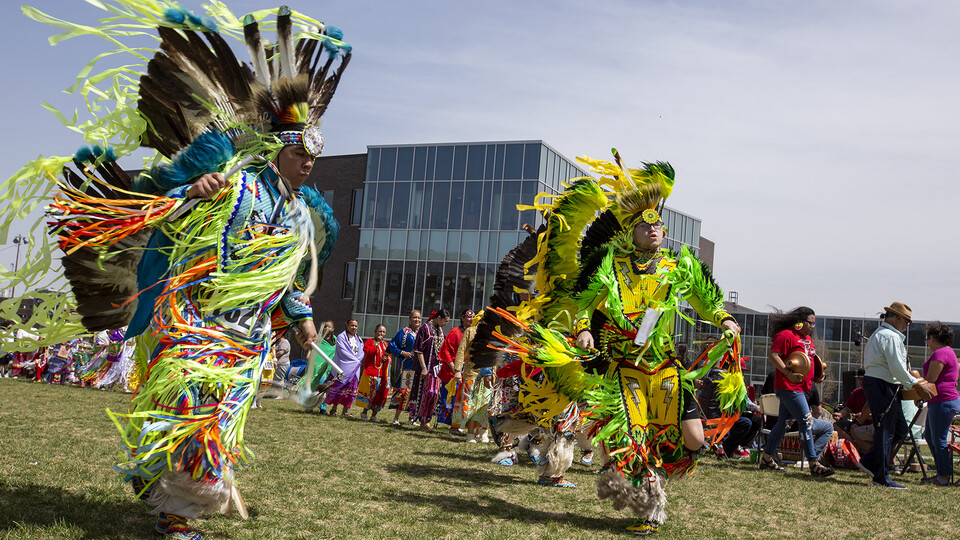 Douglas Scholfield (left) and Max Sevier dance in the men's fancy competition during the April 23 UNITE powwow. The event, which was held on the green space west of the Cather Dining Center, drew hundreds to campus.