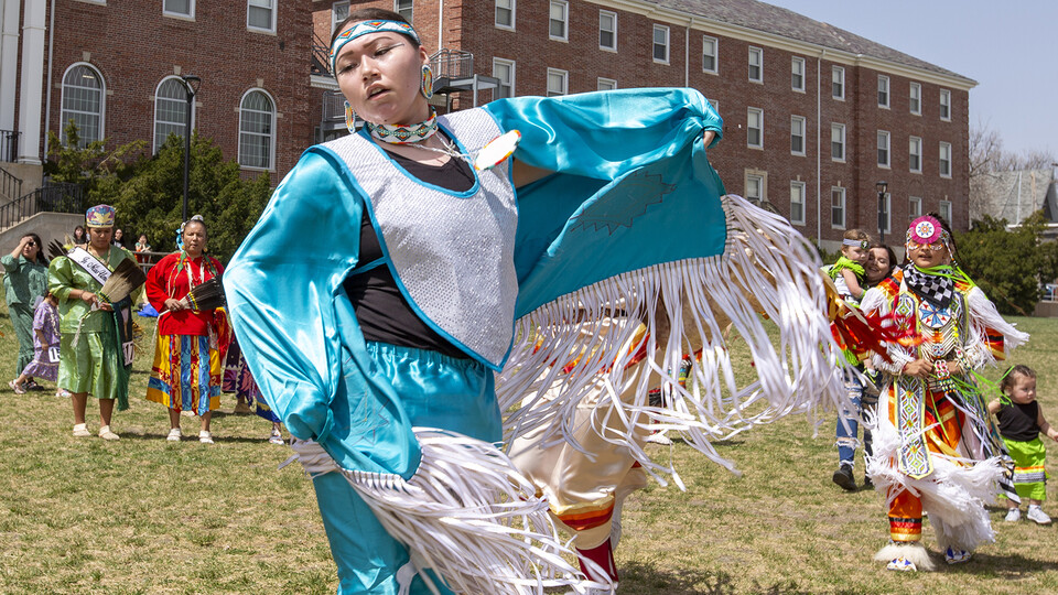 Fringe on the regalia of Stevie Horse, a member of the Ponca and Lakota tribe, flutters in the wind as she dances during an intertribal moment at the April 23 powwow.