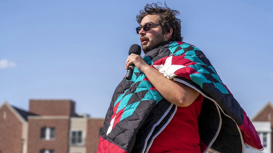 Isaiah Kluver discusses his journey after receiving a blanket as an honored graduate.