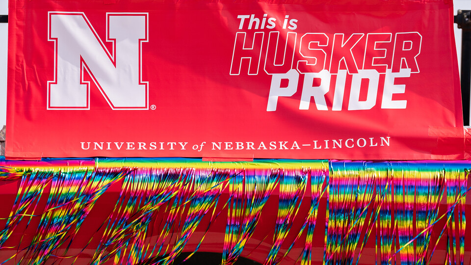 Husker Pride banner and decoration on the side of a university vehicle used during the 2022 Star City Pride parade.