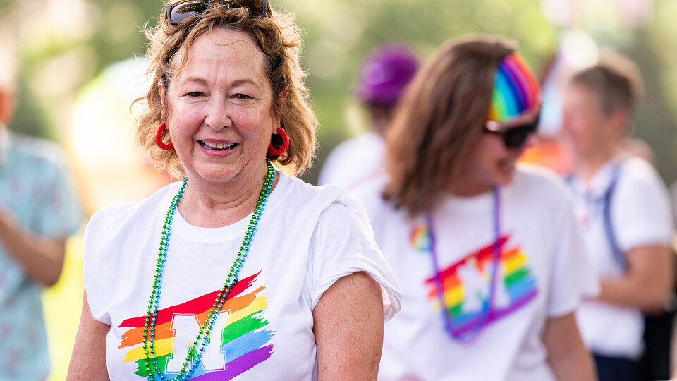 Laurie Bellows, vice chancellor for student affairs, smiles as she walks with the university's Star City Pride parade entry.