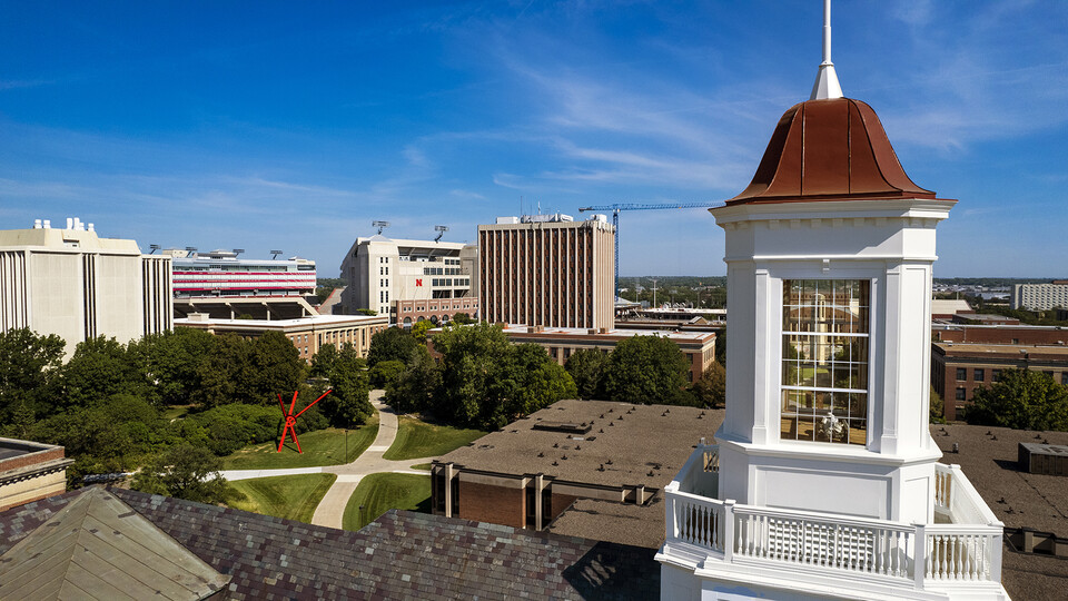 Photo of the refurbished Love Library cupola with campus in the background.