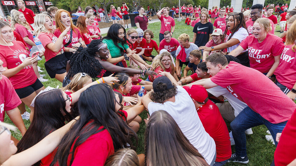 First year students stand in a circle and join hands during the Chancellor's Barbecue, one of the university's welcome back events.