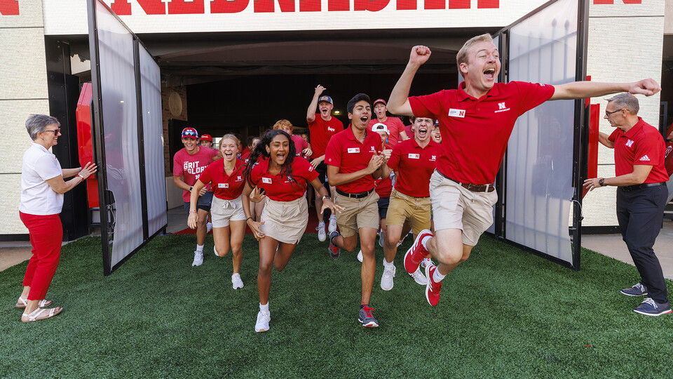 Chancellor Ronnie Green and his wife, Jane, open the gates, allowing first-year students to storm the Memorial Stadium turf during the annual Tunnel Walk celebration on Aug. 19.