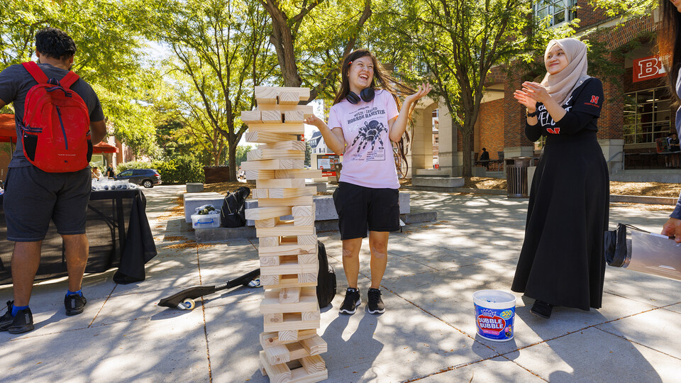 Ayela Ruiz, a freshman from Lincoln, accepts congratulations after making a difficult Jenga move from Hannah Ridzuan (right), a graduate assistant at ODI.
