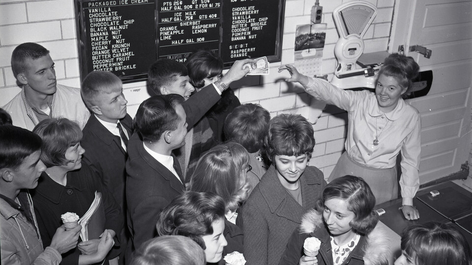 Black and white photo of many students purchasing ice cream at the UNL Dairy Store in the 1966.