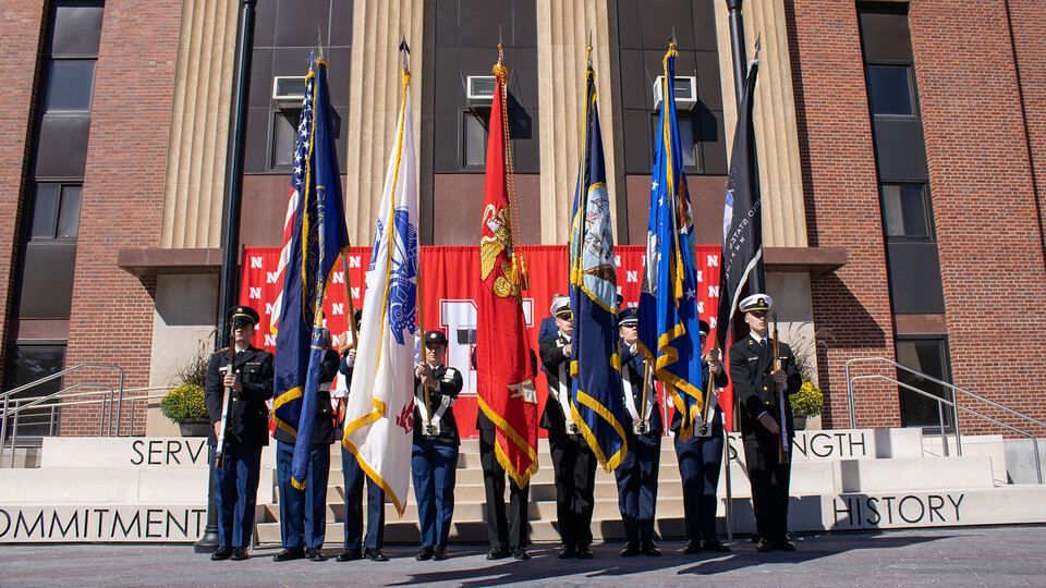 An ROTC Color Guard stands in front of Nebraska's Pershing Military and Naval Science Building during the dedication of the university's Veterans' Tribute project on Sept. 11, 2022. The project allows visitors to reflect on what it means to be a veteran and to serve the nation. It is located between the Military and Naval Science Building and the Coliseum, immediately east of Memorial Stadium.