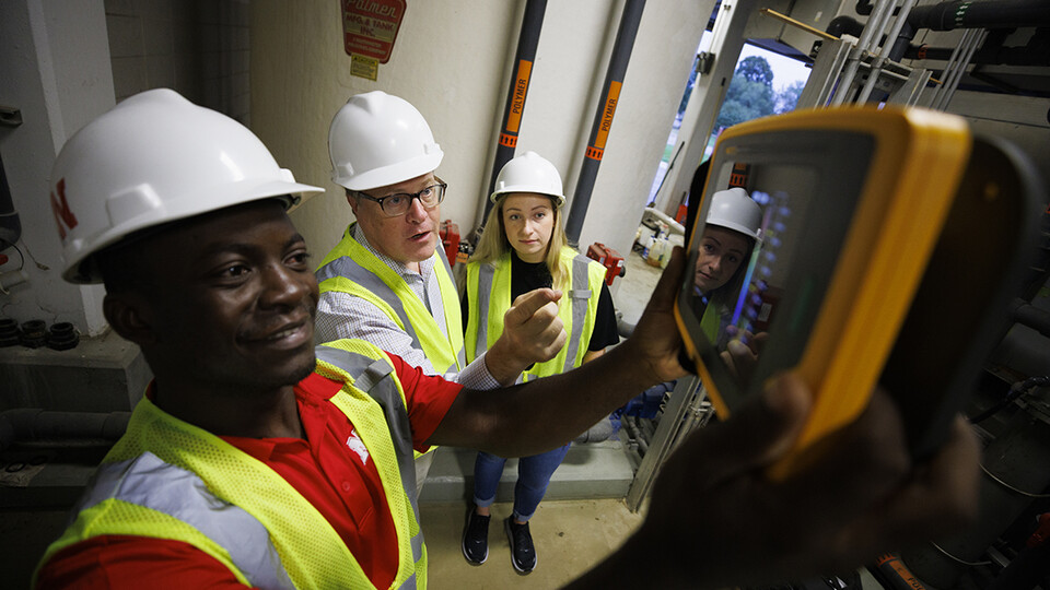 Bruce Dvorak (center), professor of civil and environmental engineering, coaches Yves Cedric Tamwo Noubissi (left), a student in mechanical engineering, and Sussan Moussavi, graduate student in civil engineering, in the use of a Fluke Precision Acoustic Imager, used to detect leaks of gases and vacuum from pipes and tanks, Sept. 23, 2022.