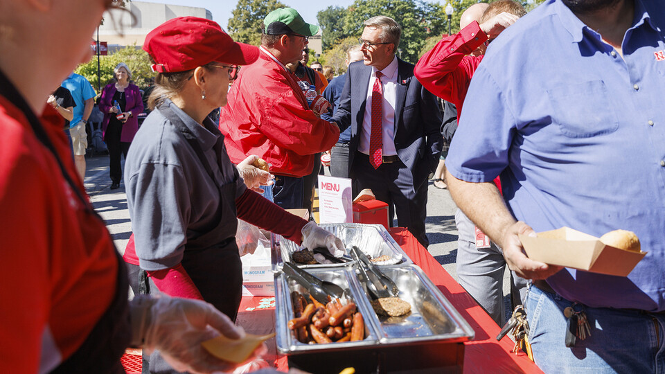 Chancellor Ronnie Green talks to employees as he waits in line during the cook-out on R Street. The event was catered by Dining Services, with nearly 1,000 attending.
