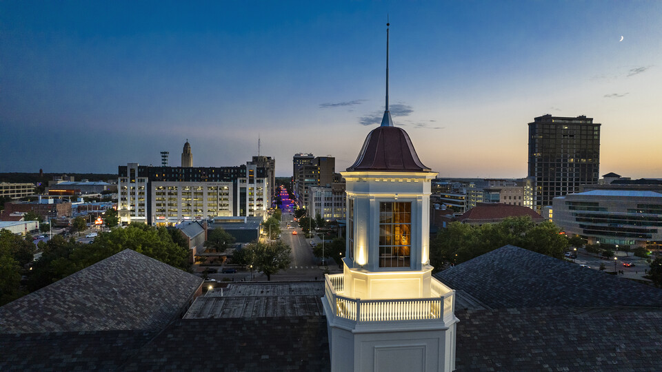 The restored cupola looks over campus at dusk