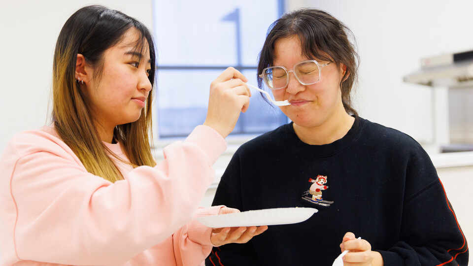 Two students cringe while trying soy sauce in the fermented foods course