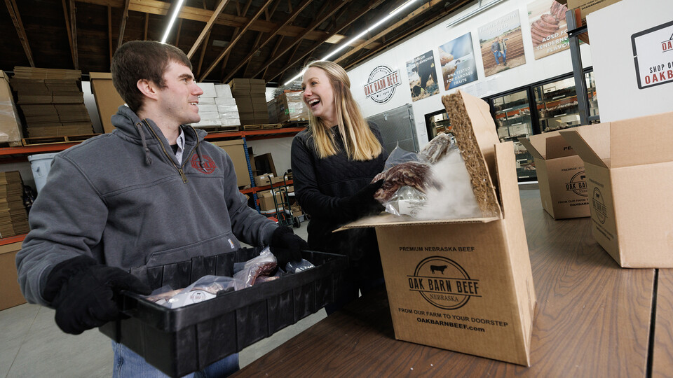 Hannah and Eric Klitz, both Engler alumni, share a laugh as they pack an order for shipment from the Oak Barn Beef store in West Point, Nebraska.