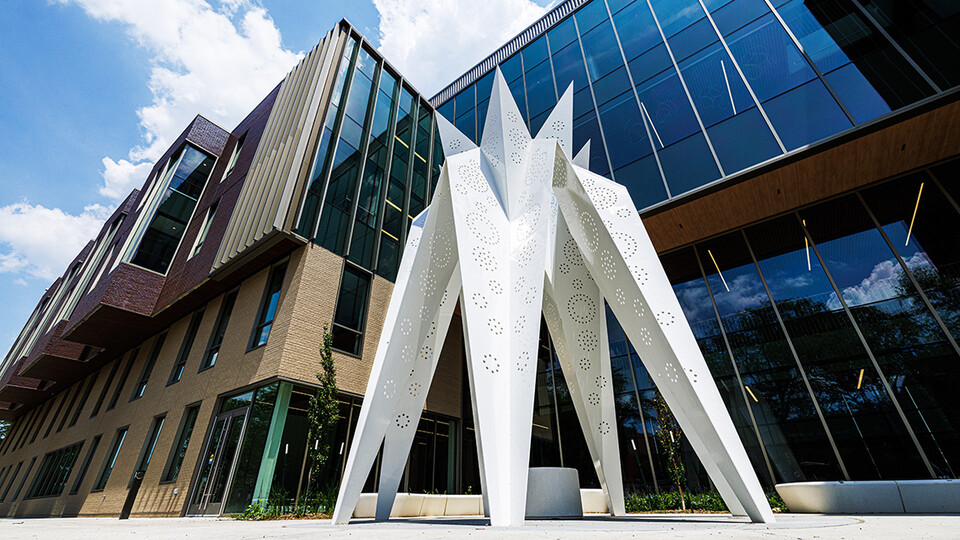 T.I.E. sculpture stands in front of Carolyn Pope Edwards Hall