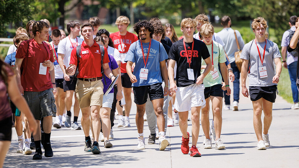 A New Student Orientation Leader takes a group of incoming students on a walking tour of campus June 7.
