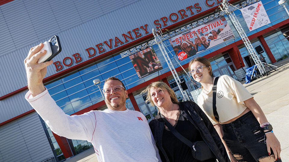 Marissa Brewer of Omaha, right, poses for a selfie with her mom and dad, John and Michelle, as they enter Devaney Sports Center to start the move in process. 