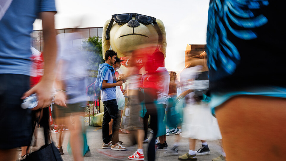 Godzilla Cane watches over the blur of students at the Big red Welcome Street Fest on the Memorial Stadium loop.