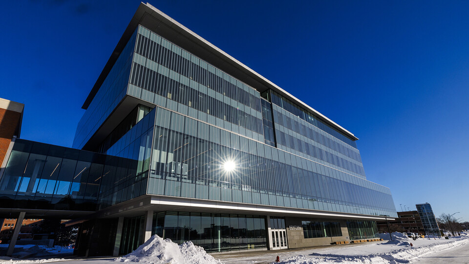 Photo of the facade of Nebraska Engineering's new Kiewit Hall. The six-story building features an all-glass facade.