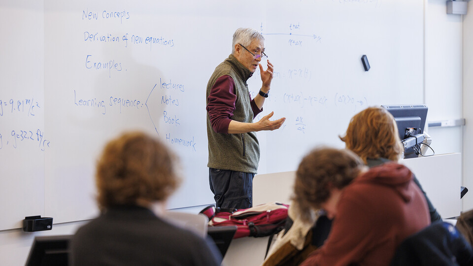 Jiashi Yang stands in front of a white board as he teaches engineering dynamics on the opening day of Kiewit Hall.