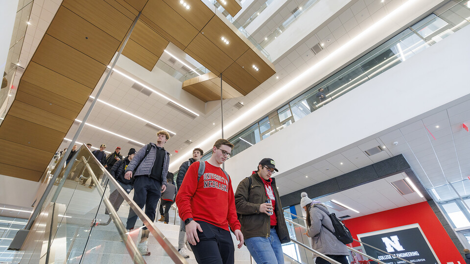 Students walk down the six-story staircase in Kiewit Hall. The rises nearly 100 feet from the basement to the college’s offices on the sixth floor. Five stories of the staircase hang from the roof rather than being supported in a more traditional manner on the ground.
