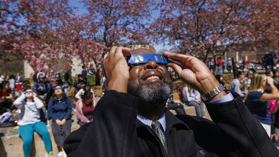 Chancellor Rodney D. Bennett observes the eclipse during the April 8 celebration.