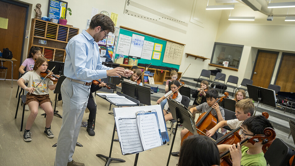 Dameer Gustafson, junior music education major, teaches the UNL/LPS String Project second-year class in preparation for their concert April 17.