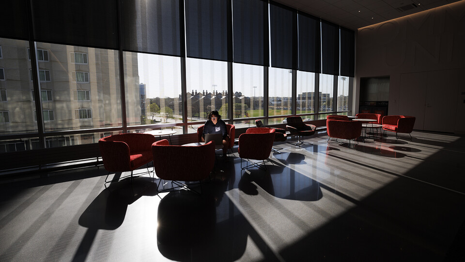 Afternoon sunshine and the architecture of Kiewit Hall mingle to form a bar graph of light and shadow as Alberto Rodriguez, a senior mechanical engineering major, studies for a statistics course.