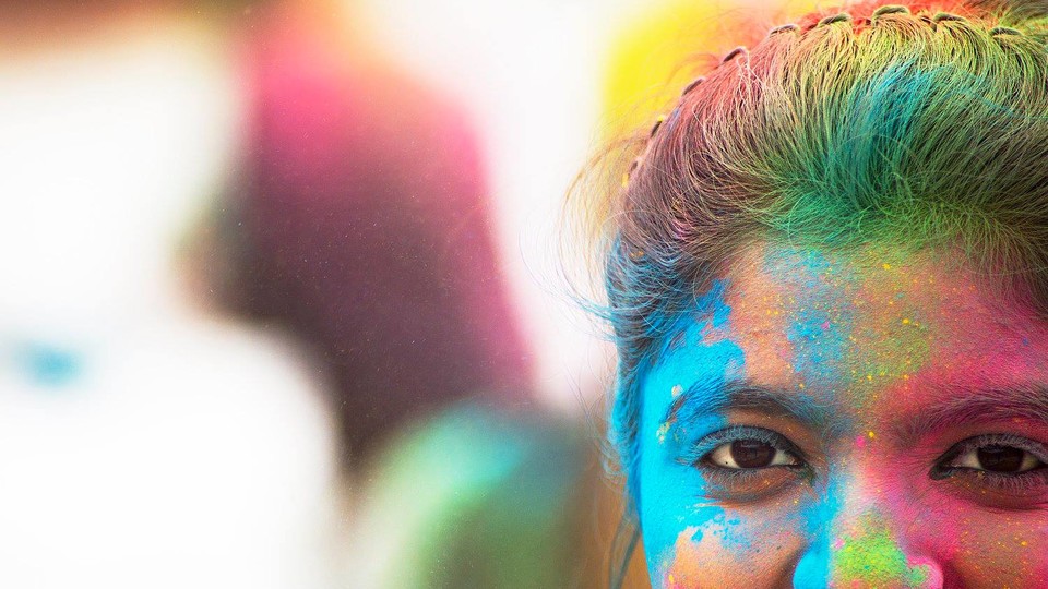 A Nebraska student stands covered by colored powder following the Holi celebration on April 15. The celebration, which is a tradition in India, used colored powder made from food-grade, biodegradable products with FDA approved dyes.
