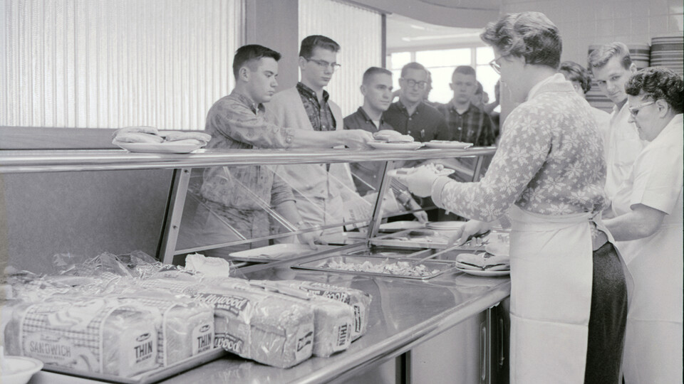 Students go down the line as workers serve them food in the Selleck Quadrangle dining center in February 1963.