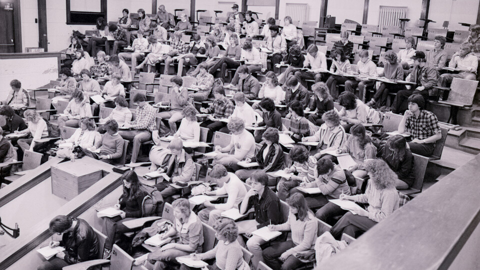 Students take notes in a large campus lecture hall in 1982.