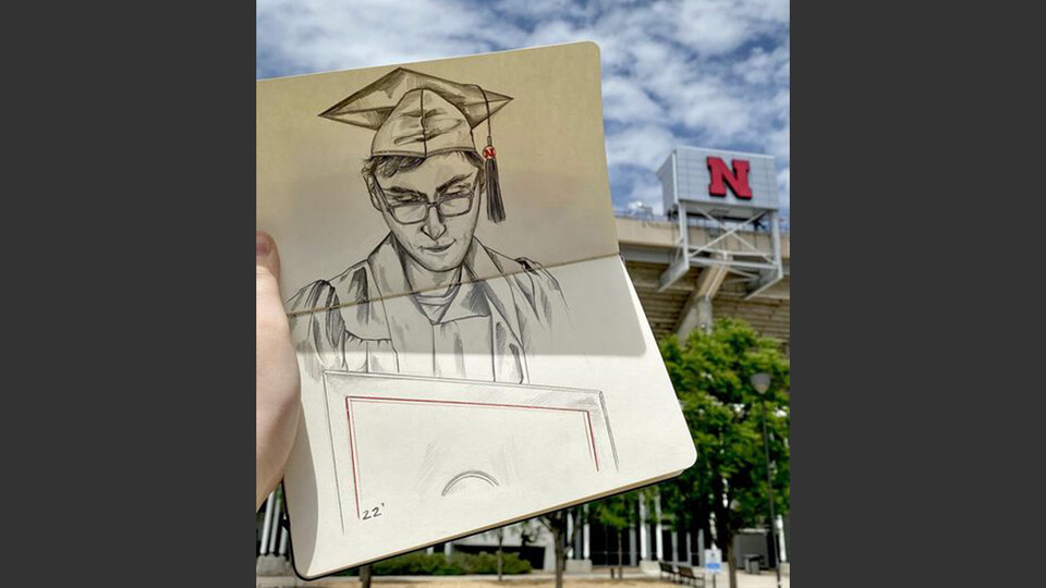 Drawing of a graduate held in front of Memorial Stadium.