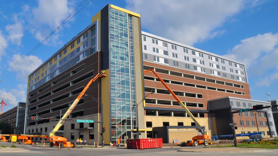The $50 million 50/50 building on the corner of 18th and R streets features 1,605 parking spaces and 124 apartments. UNL will manage the parking structure, offering 1,270 spaces to students living in nearby residence halls. America First Real Estate will manage the living space in the building.