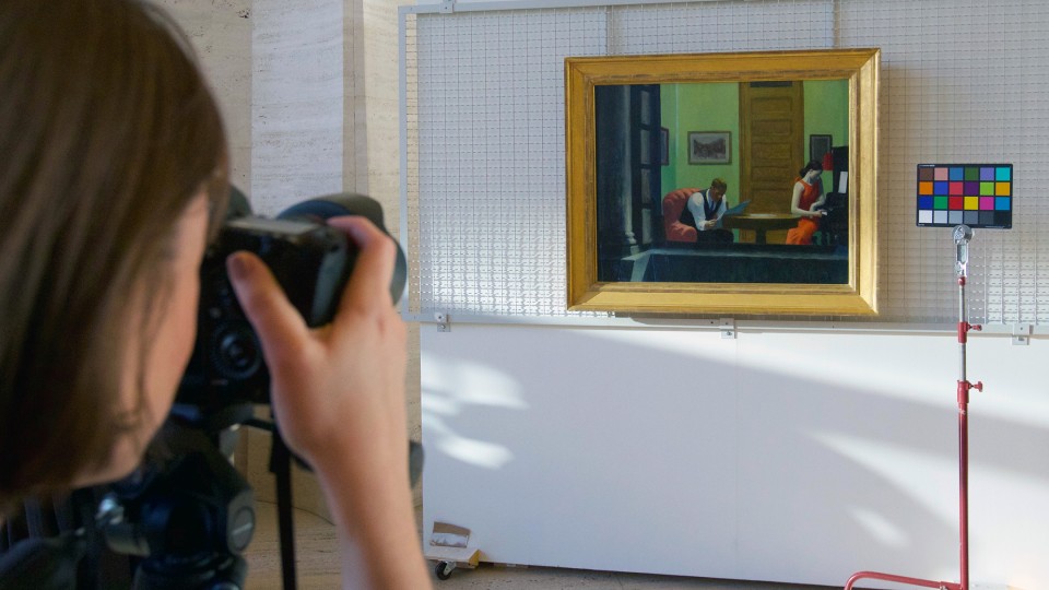 A Sheldon Museum of Art employee shoots a photo of Edward Hopper's "Room in New York" as part of a demonstration held during an April 7 celebration of the museum's digitization project. When complete, photos and information about all 12,866 items in the museum collection will be available online.