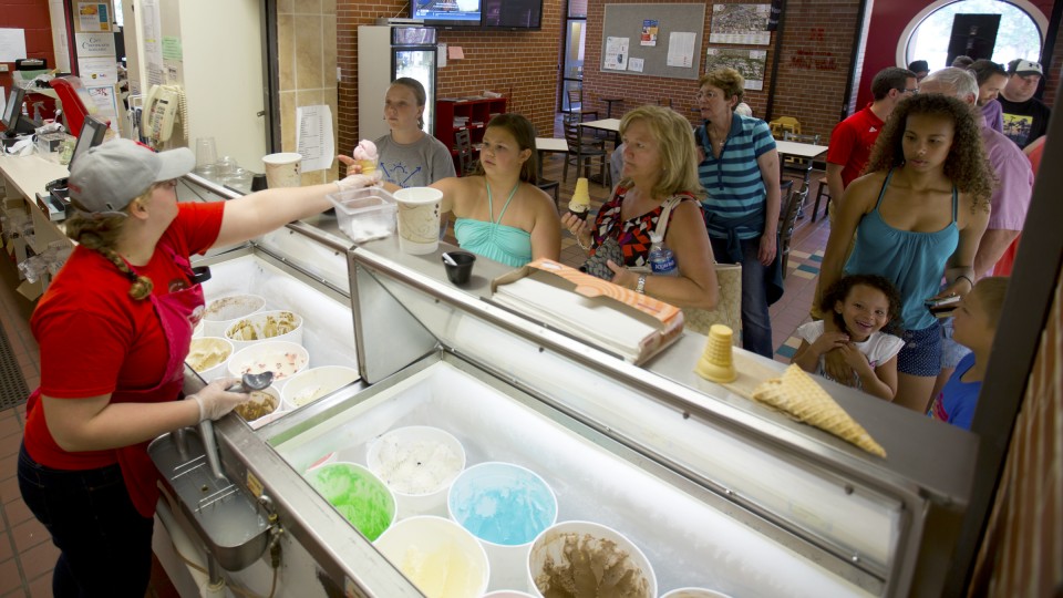 UNL Dairy Store employee Katherine Mudorf serves ice cream to patrons during happy hour on July 8. The East Campus ice cream shop is open daily from 11 a.m. to 9 p.m.