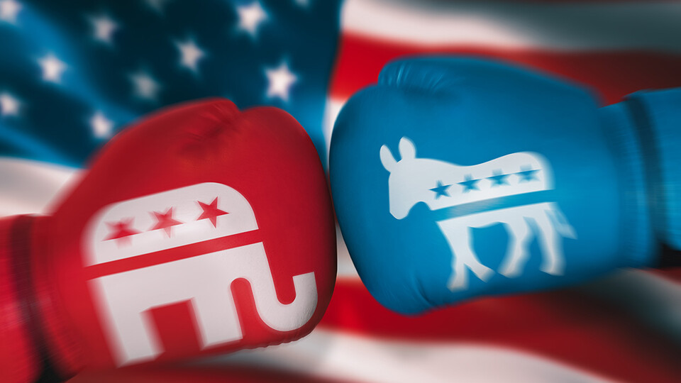 Two boxing gloves inscribed with political symbols is a metaphor for political battles.